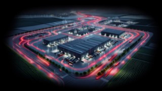 Les solutions Fenwick contribuent à sécuriser les flux de production dans l’industrie automobile. Entrepôt vu du ciel la nuit